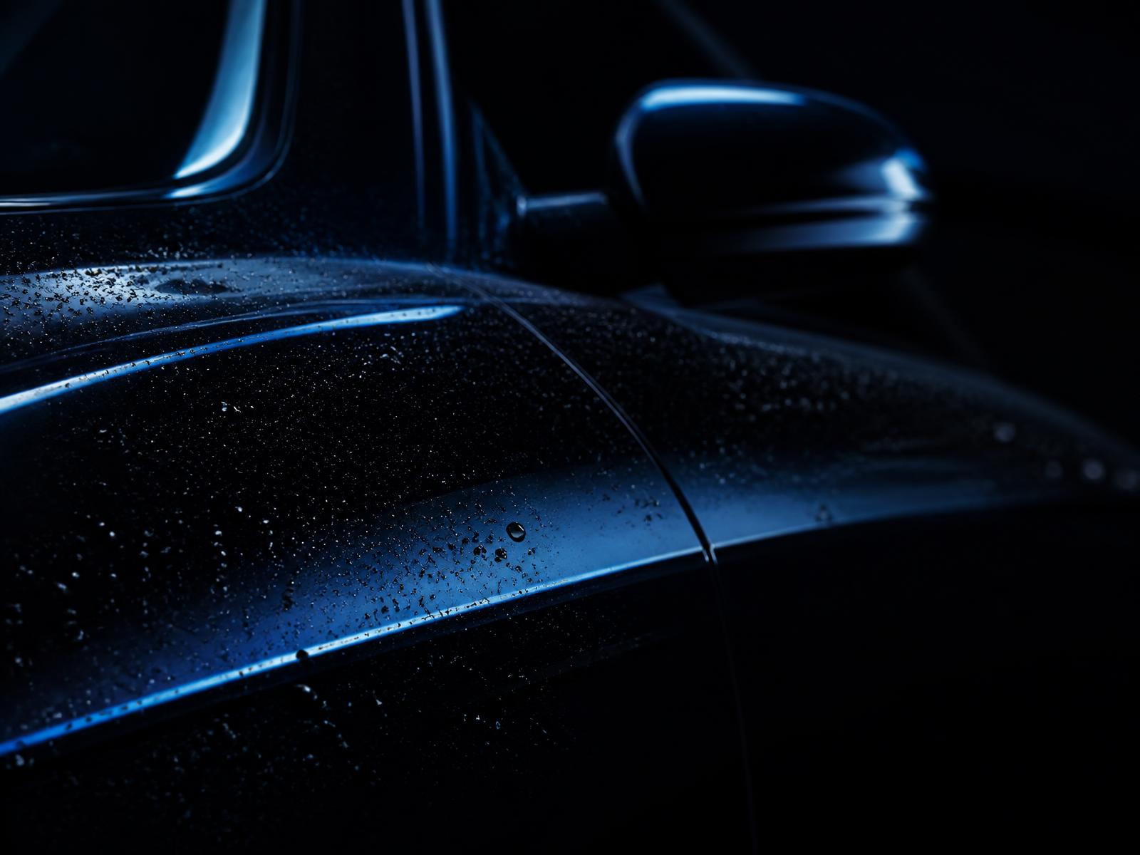 Glossy freshly detailed car body with water beading
